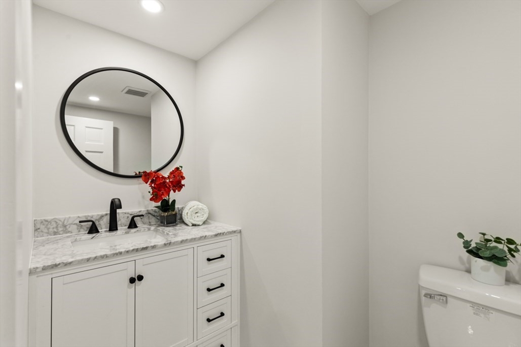 17 Saunders Road Lynnfield, MA 01940 - Photo 31 of 42 a bathroom with a granite countertop sink and a mirror