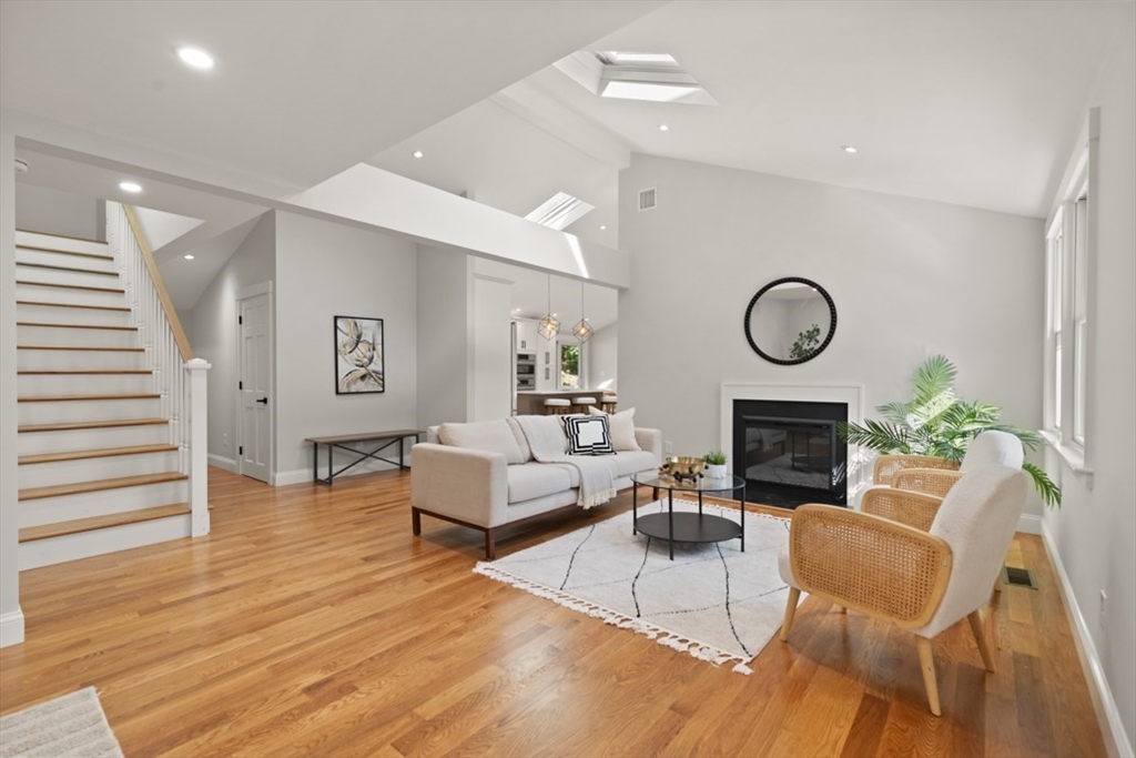 17 Saunders Road Lynnfield, MA 01940 - Photo 8 of 42 a living room with furniture a fireplace and wooden floor