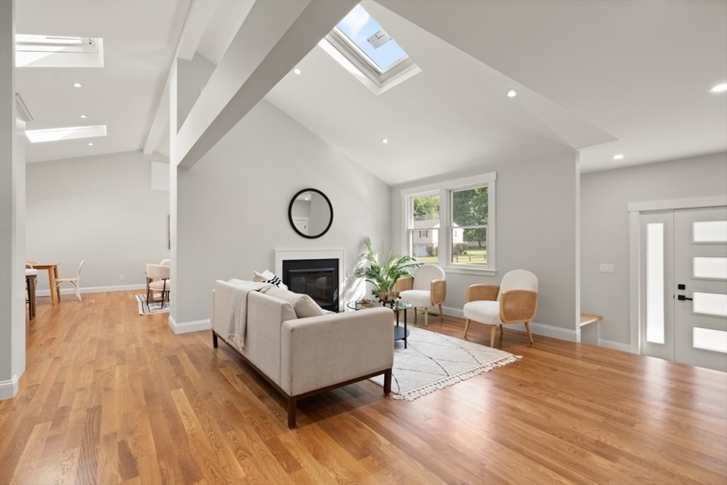 17 Saunders Road Lynnfield, MA 01940 - Photo 9 of 42 a living room with furniture and a fireplace