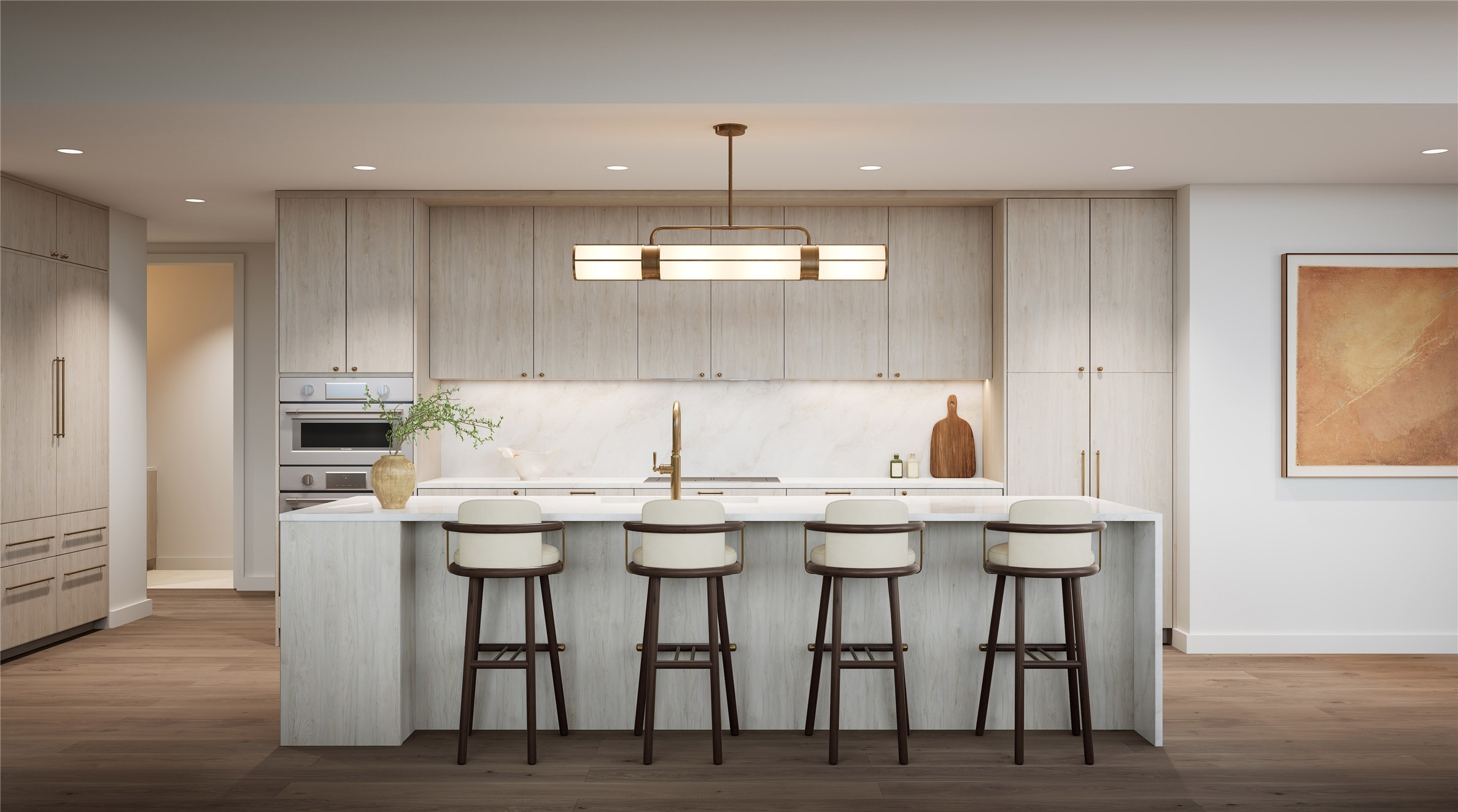 Kitchen in Tranquil palette featuring a large breakfast bar, designer lighting, wood flooring, recessed lights, and natural stone quartzite countertops. Fully integrated Thermador appliance suite — including refrigerator, induction cooktop, wall oven, dishwasher, and built-in wine preservation tower — all standard, not upgrade. Soft, light-toned cabinetry and subtle detailing create an airy, refined aesthetic. Representative finish shown; three palettes available, design varies by residence.
