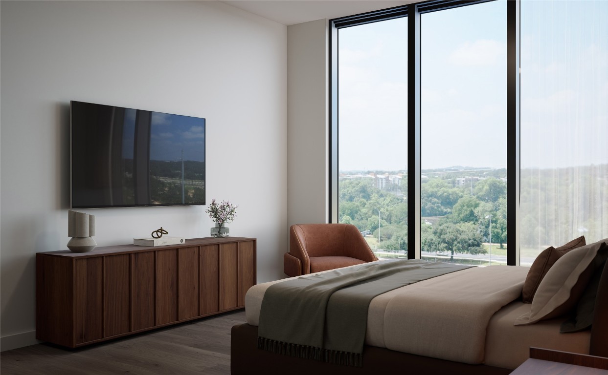 300 Pressler Street, Unit 216 Austin, TX 78703 - Photo 17 of 18 Bedroom featuring recessed lighting, wood flooring, and a large picture window. Designed with warm, neutral tones and clean architectural lines that create a calm and restful environment.