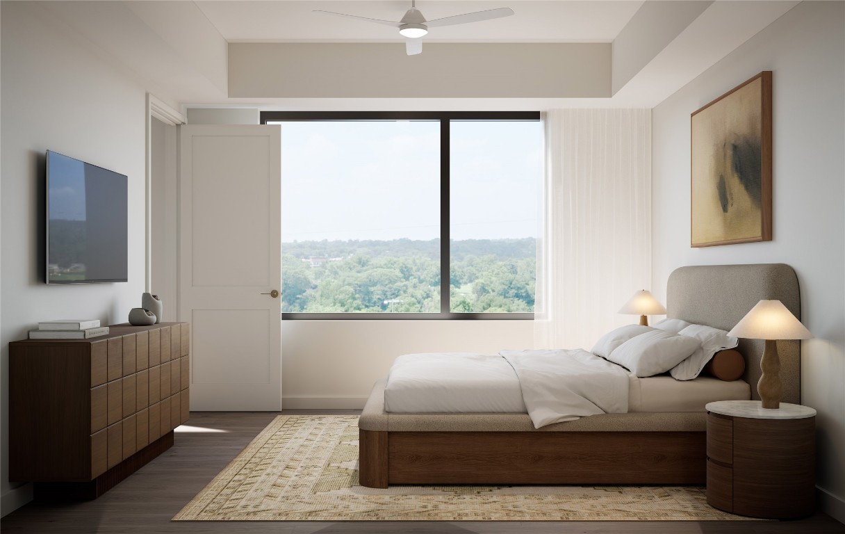 300 Pressler Street, Unit 216 Austin, TX 78703 - Photo 18 of 18 Bedroom showcasing soft natural light, wood flooring, and warm neutral finishes. Features a picture window with vista and treetop views, creating a serene, well-balanced retreat.