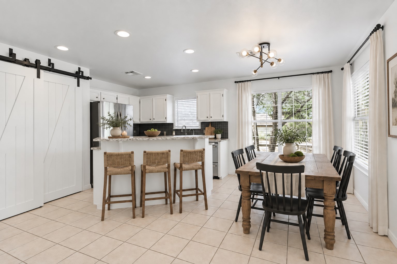 104 Crazy Cross Road Wimberley, TX 78676 - Photo 7 of 20 Tiled floors and recessed lighting anchor this open-concept dining area and kitchen space.