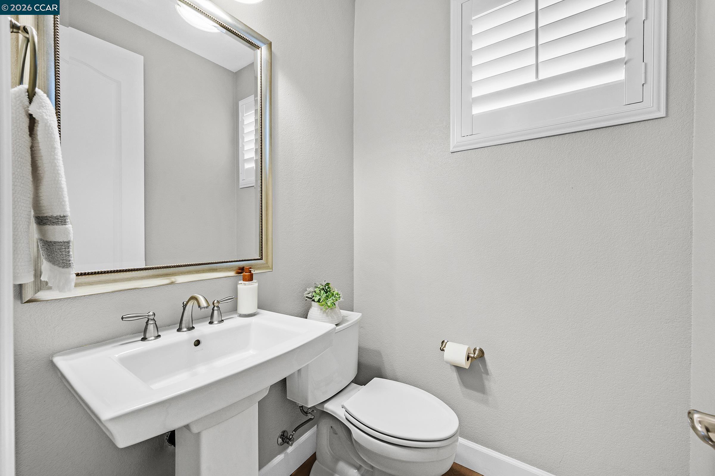 111 Elworthy Ranch Drive Danville, CA 94526 - Photo 16 of 43 a bathroom with a toilet a sink a mirror and a window