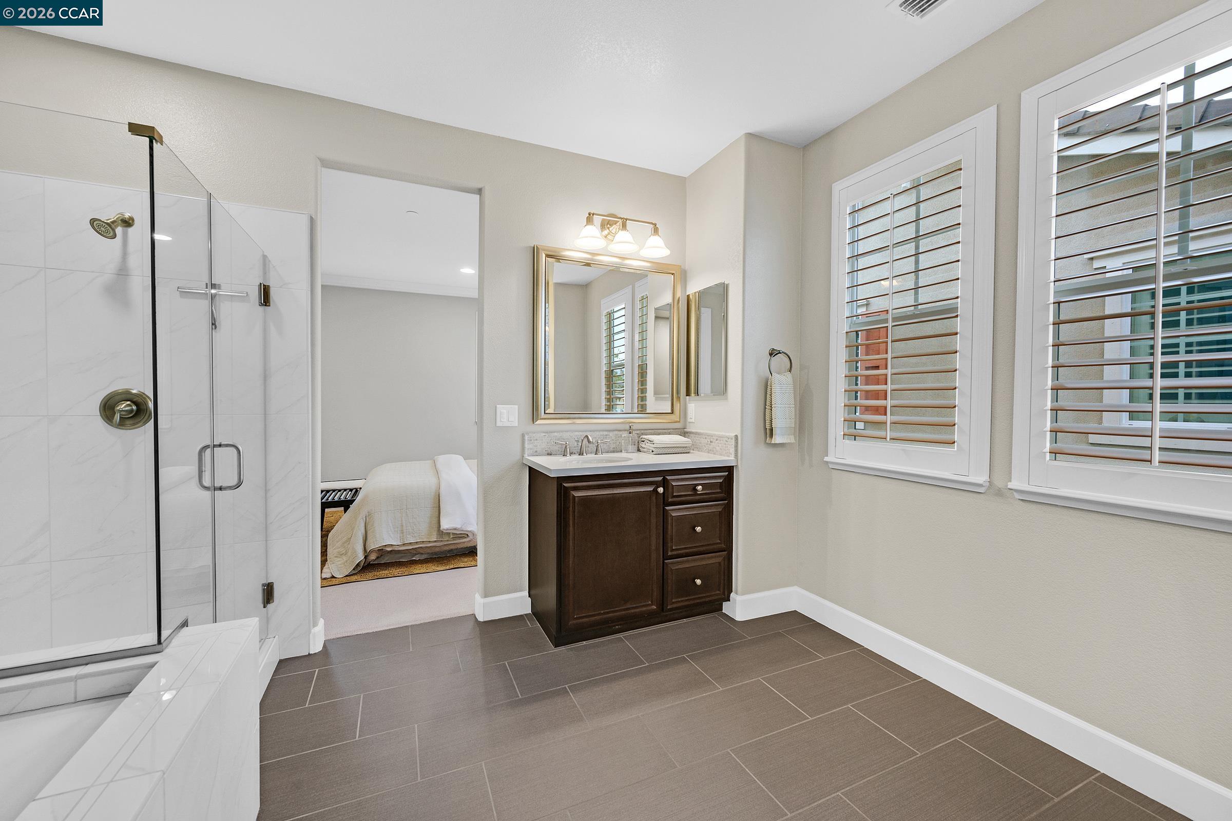 111 Elworthy Ranch Drive Danville, CA 94526 - Photo 30 of 43 a en suite bathroom with a double vanity sink a mirror and a shower