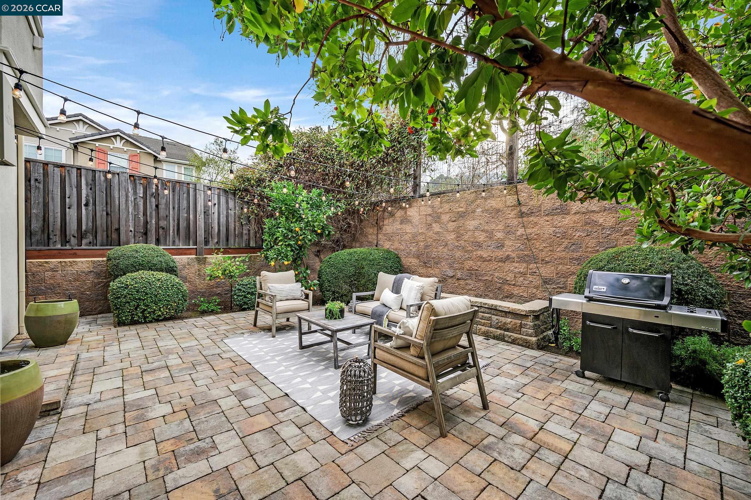 111 Elworthy Ranch Drive Danville, CA 94526 - Photo 35 of 43 a view of a patio with table and chairs potted plants and wooden fence