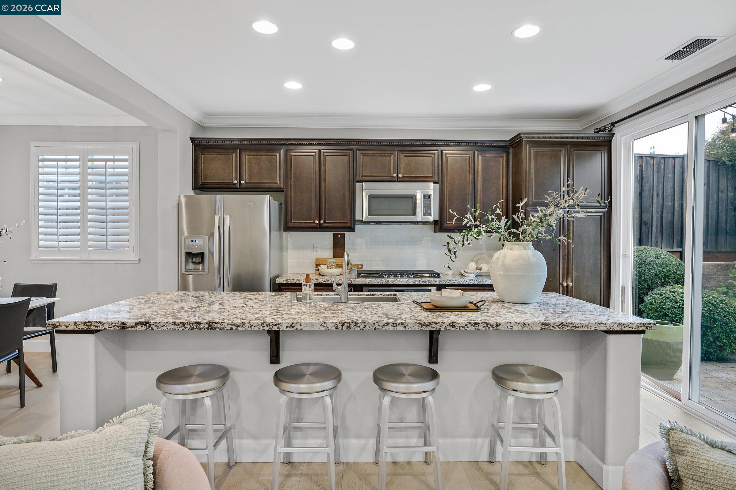 111 Elworthy Ranch Drive Danville, CA 94526 - Photo 9 of 43 a kitchen with stainless steel appliances granite countertop a kitchen island a stove a sink a refrigerator and cabinets