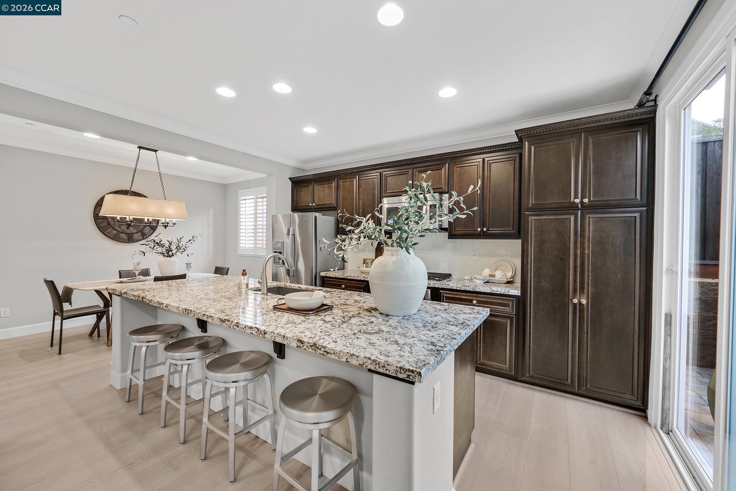 111 Elworthy Ranch Drive Danville, CA 94526 - Photo 10 of 43 a view of kitchen island with stainless steel appliances granite countertop furniture stove top oven and refrigerator