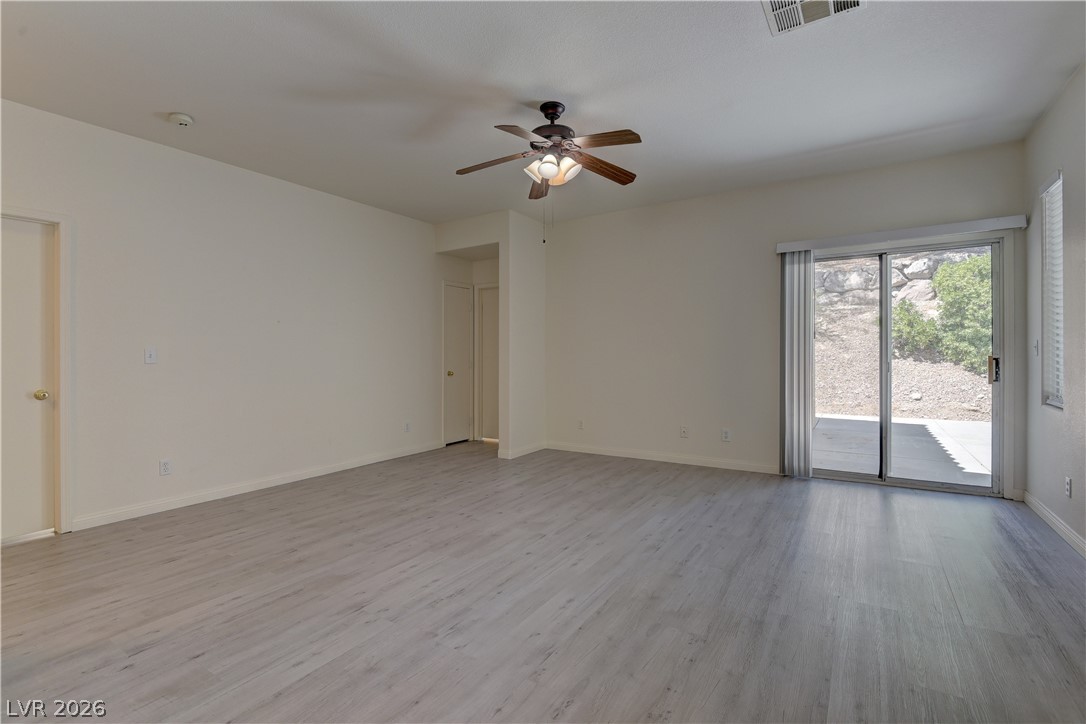 4613 Rising Cove Street Las Vegas, NV 89129 - Photo 4 of 20 This bright living space features durable flooring and a private outdoor connection.