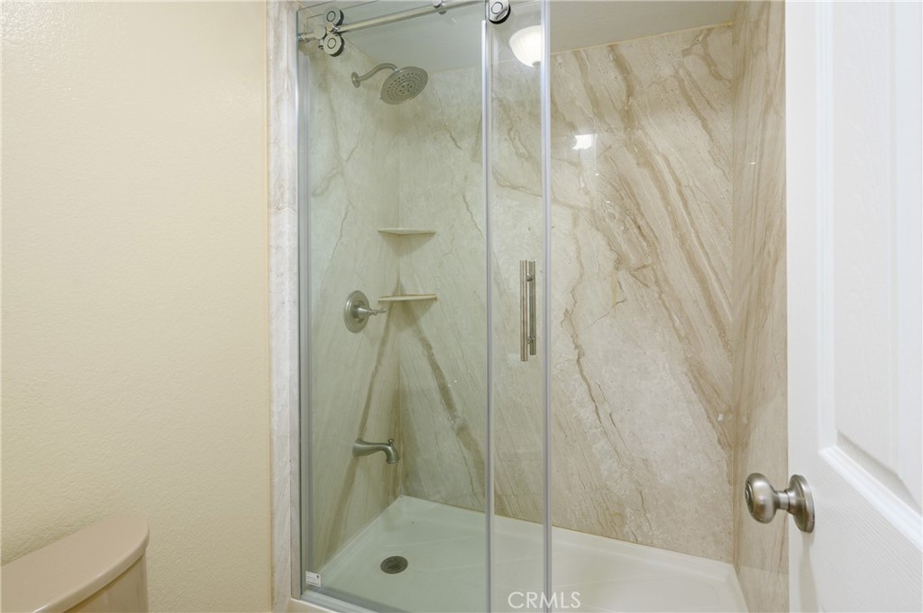 36 Corniche Drive, Unit B Dana Point, CA 92629 - Photo 20 of 37 Full marble wall in the walk in shower