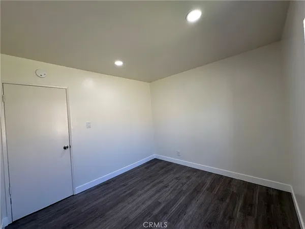 a view of room with wooden floor