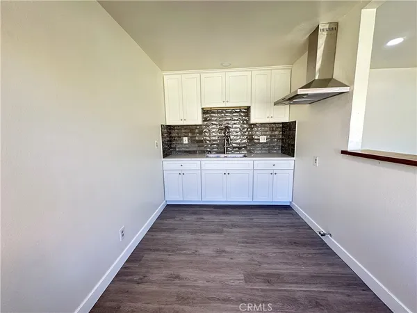 a kitchen with granite countertop a sink and a stove