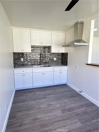 a kitchen with granite countertop a sink and a stove