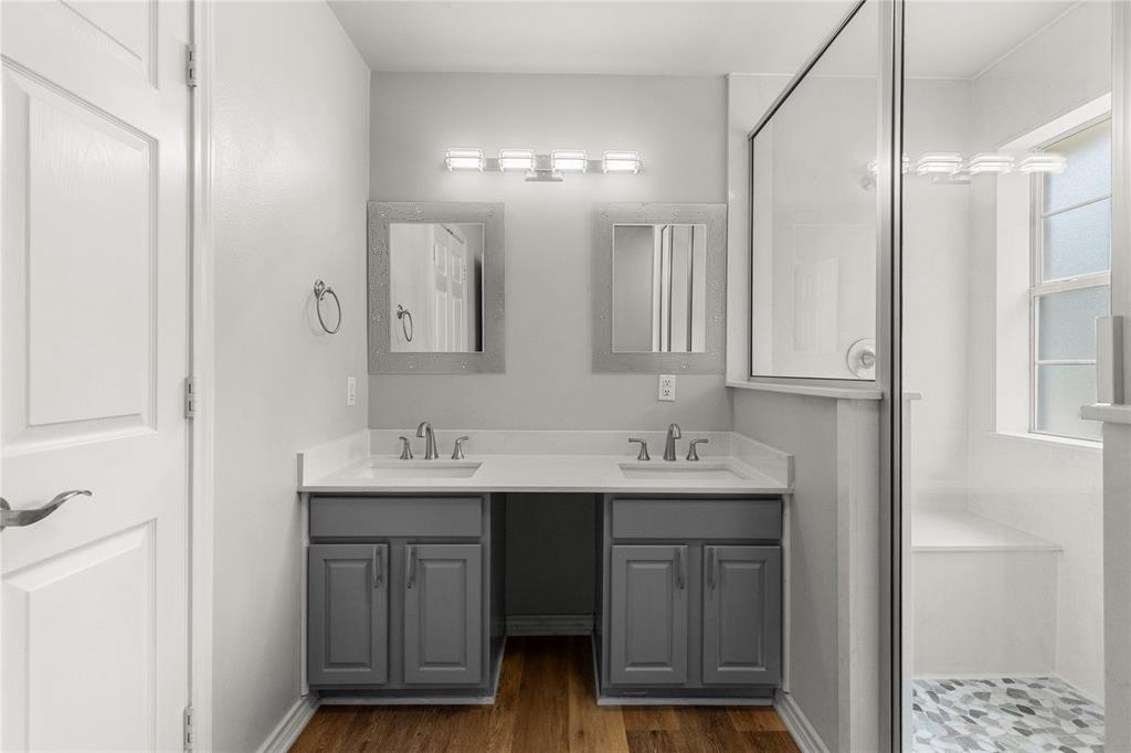 2917 Harlow Road Commerce, TX 75428 - Photo 13 of 40 a bathroom with a sink and a mirror