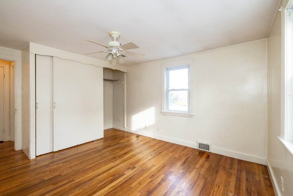 43 E Street Hull, MA 02045 - Photo 7 of 12 wooden floor in an empty room with a window