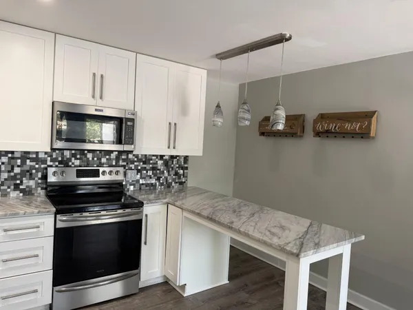 a kitchen with cabinets and steel appliances