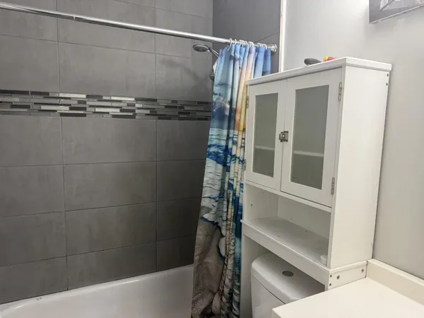 a bathroom with a shower and a sink
