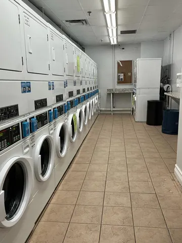 a view of a kitchen with stainless steel appliances granite countertop a sink and cabinets