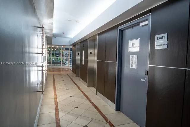 a bathroom with a glass door shower and sink
