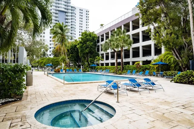 a view of swimming pool with outdoor seating and plants