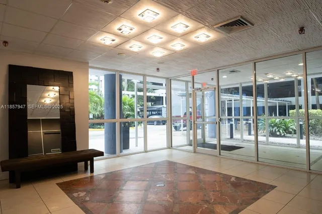 a view of a lobby with furniture and floor to ceiling window