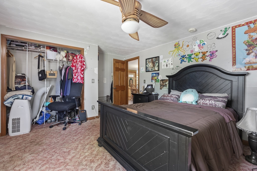 20 1/2 Bliss Street, Unit 2 Taunton, MA 02780 - Photo 13 of 18 a bedroom with a bed and a chandelier