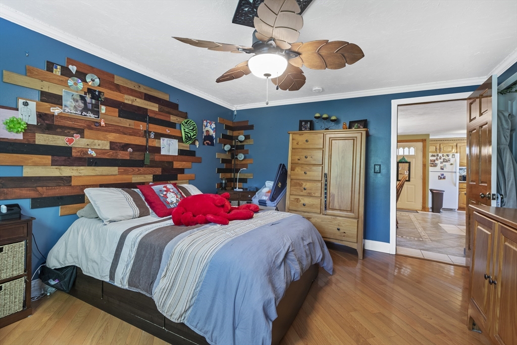 20 1/2 Bliss Street, Unit 2 Taunton, MA 02780 - Photo 15 of 18 a bedroom with a bed and a chandelier