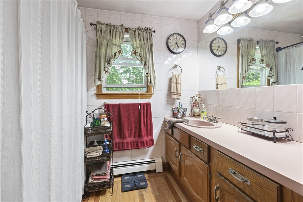 20 1/2 Bliss Street, Unit 2 Taunton, MA 02780 - Photo 18 of 18 a kitchen with a refrigerator and a clock on the wall