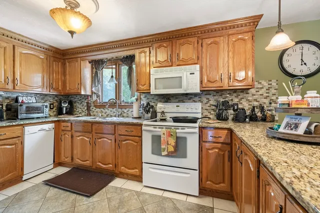 a kitchen with stainless steel appliances granite countertop a stove sink and cabinets