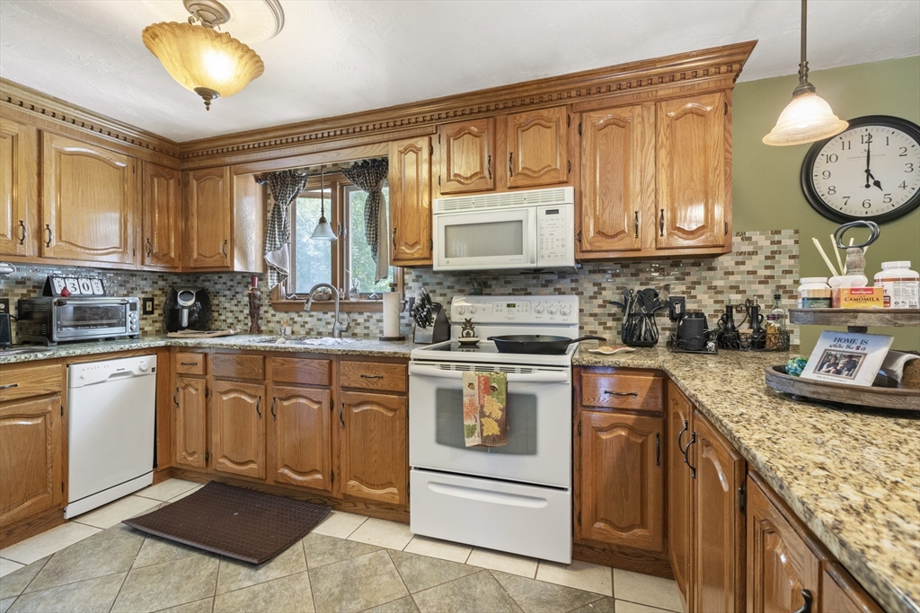 20 1/2 Bliss Street, Unit 2 Taunton, MA 02780 - Photo 3 of 18 a kitchen with stainless steel appliances granite countertop a stove sink and cabinets