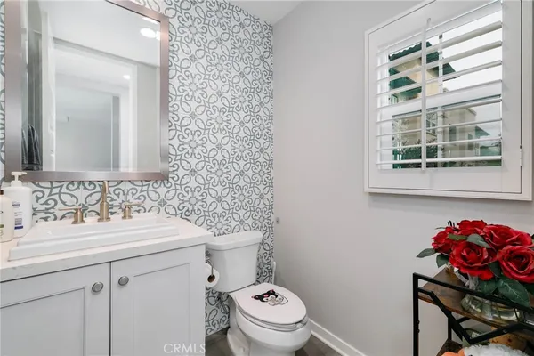 a bathroom with a sink mirror and toilet