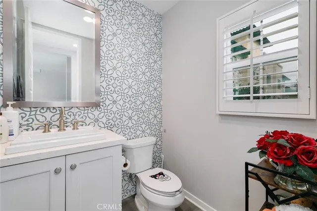 a bathroom with a sink mirror and toilet