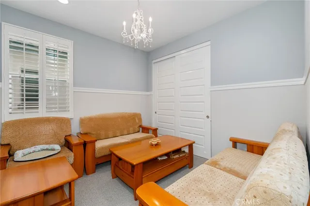 a bedroom with furniture and a chandelier