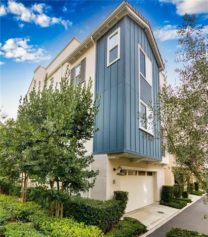 a front view of a house with plants