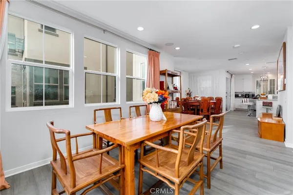 a dining room with furniture and wooden floor