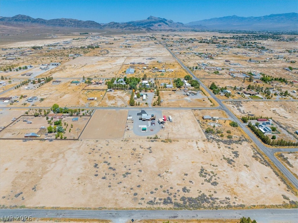 4580 Lawrence Road Pahrump, NV 89048 - Photo 33 of 40 A vast desert expanse reveals scattered homes and the distant mountain range under a clear sky.