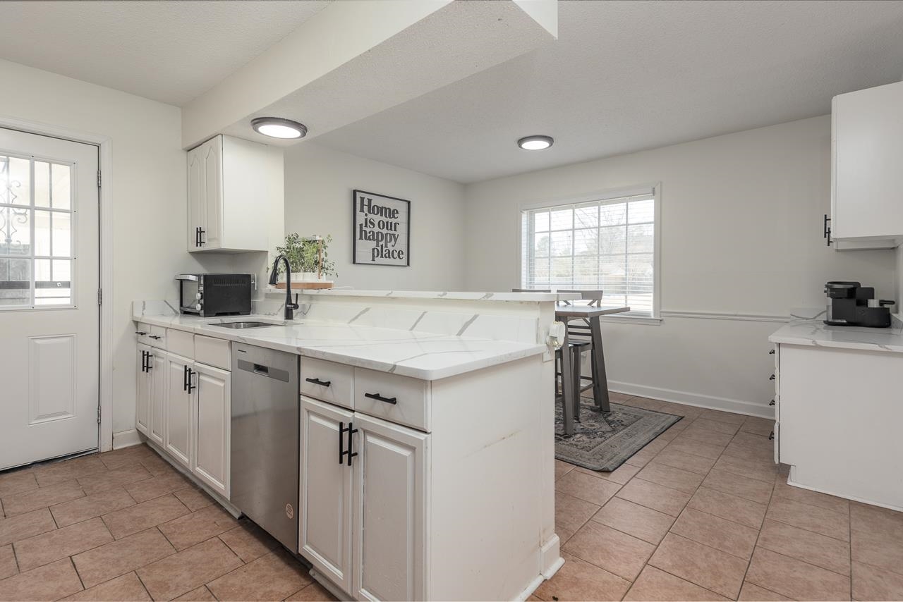 2835 McVay Trail Drive Memphis, TN 38119 - Photo 12 of 29 Kitchen with white cabinets, dishwasher, kitchen peninsula, and sink
