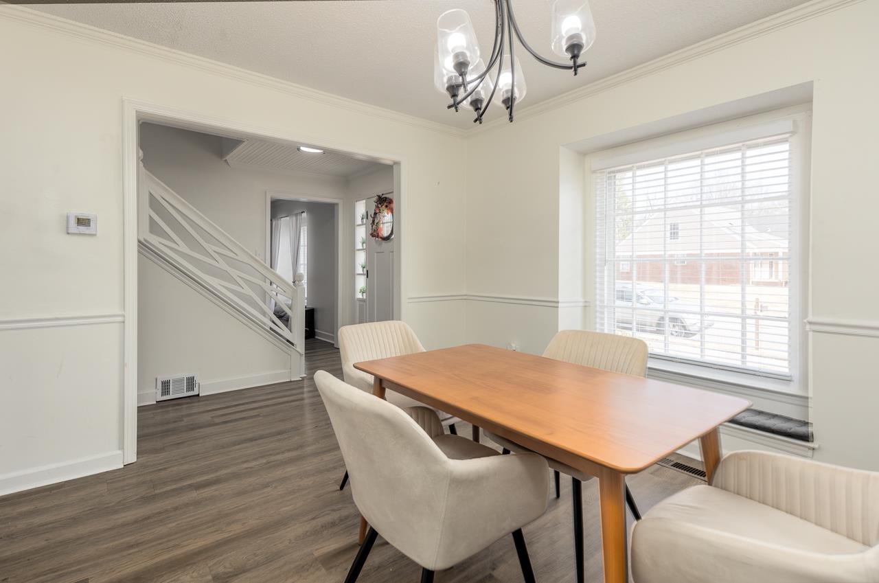 2835 McVay Trail Drive Memphis, TN 38119 - Photo 9 of 29 Dining area featuring a chandelier, crown molding, and dark hardwood / wood-style flooring