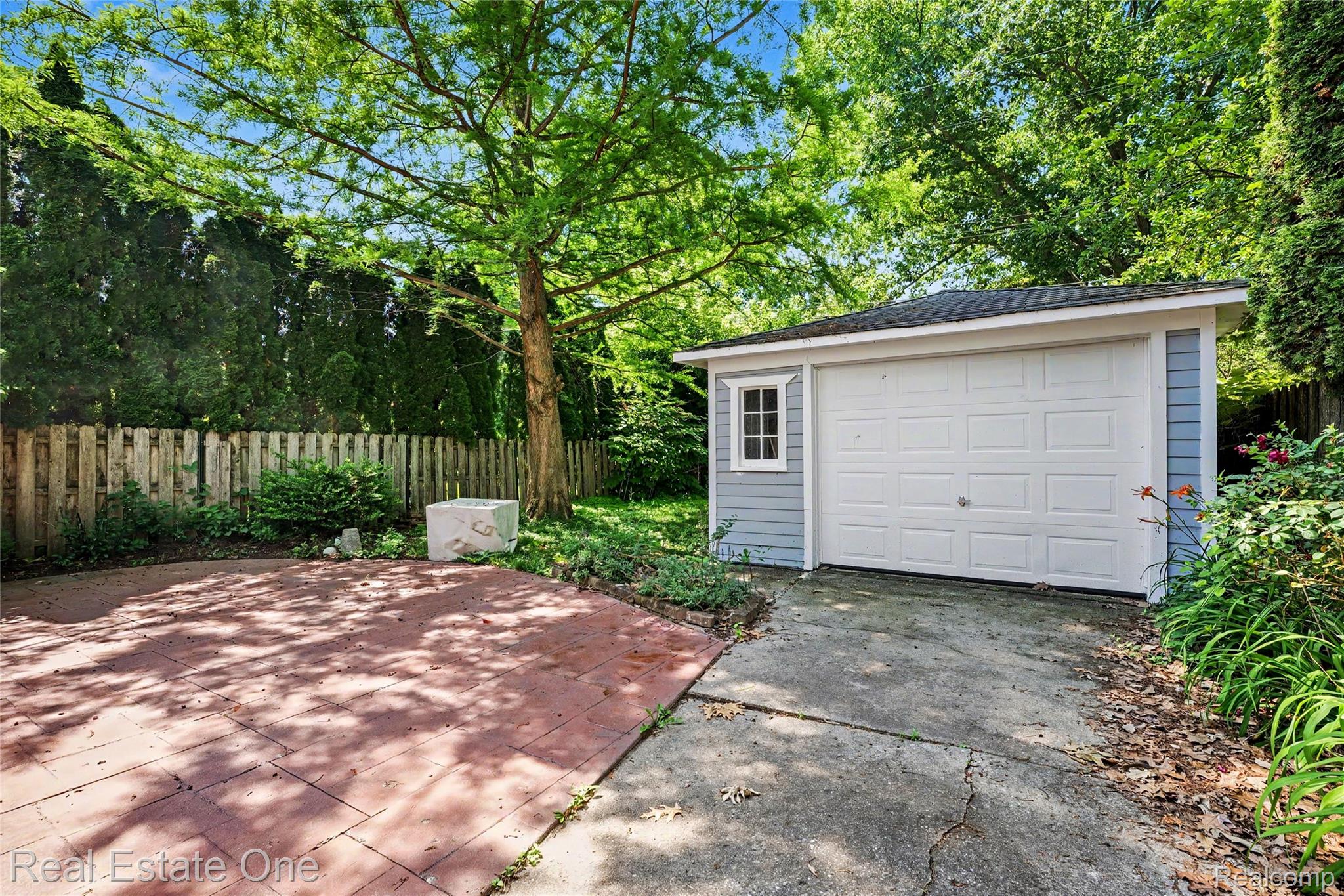 2073 Roslyn Road Grosse Pointe, MI 48236 - Photo 24 of 30 Detached garage featuring light blue siding, a white panel door, and a single pane window