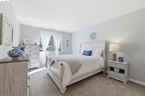 a bed room with a bed and a television