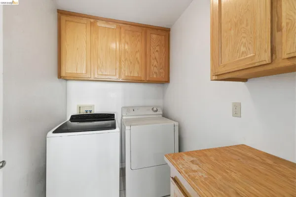 a view of a balcony with wooden floor and fence