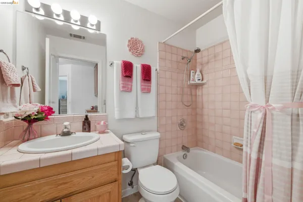 a view of a patio with table and chairs under an umbrella