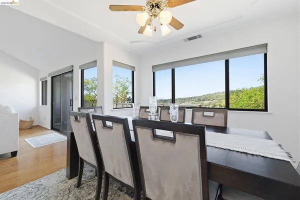 a view of a dining room with furniture window and wooden floor