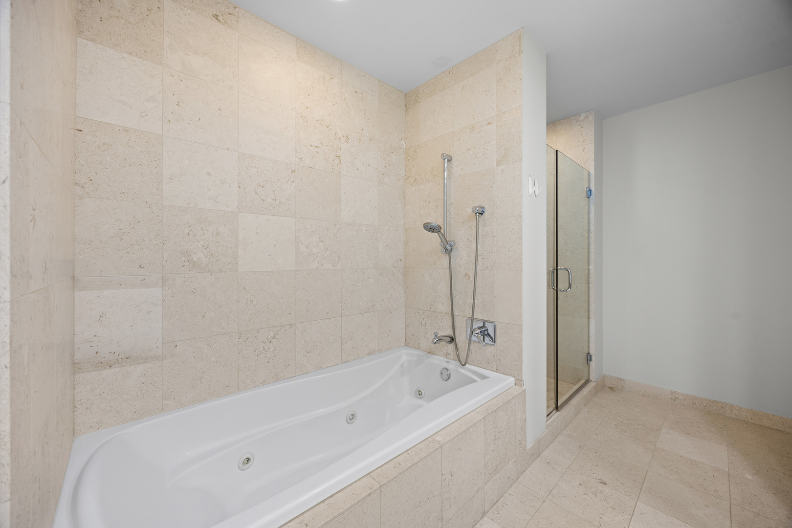 60 East Monroe Street, Unit 2307 Chicago, IL 60603 - Photo 15 of 27 a bathroom with a bathtub and a shower