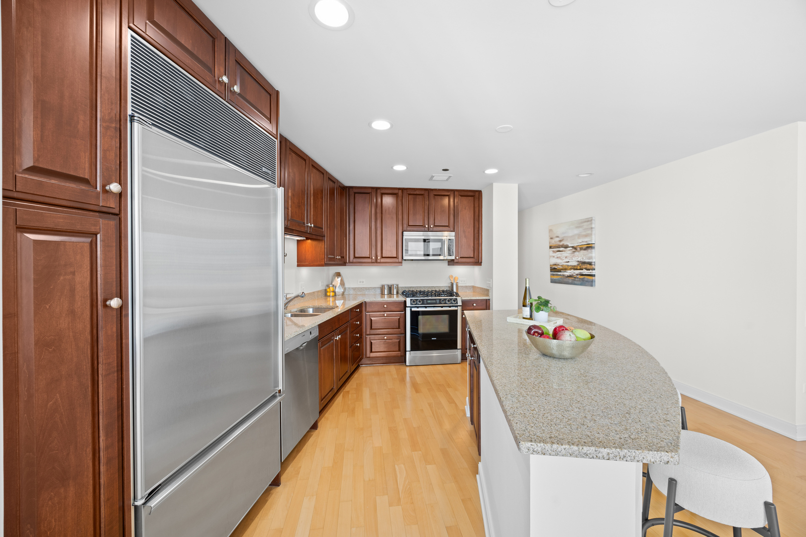 60 East Monroe Street, Unit 2307 Chicago, IL 60603 - Photo 10 of 27 a kitchen with granite countertop stainless steel appliances a refrigerator and a stove top oven