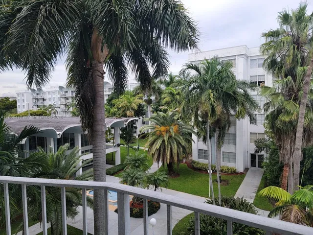 a view of a palm trees front of house