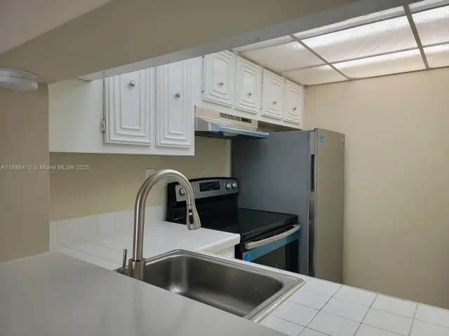 a close view of a sink and cabinets