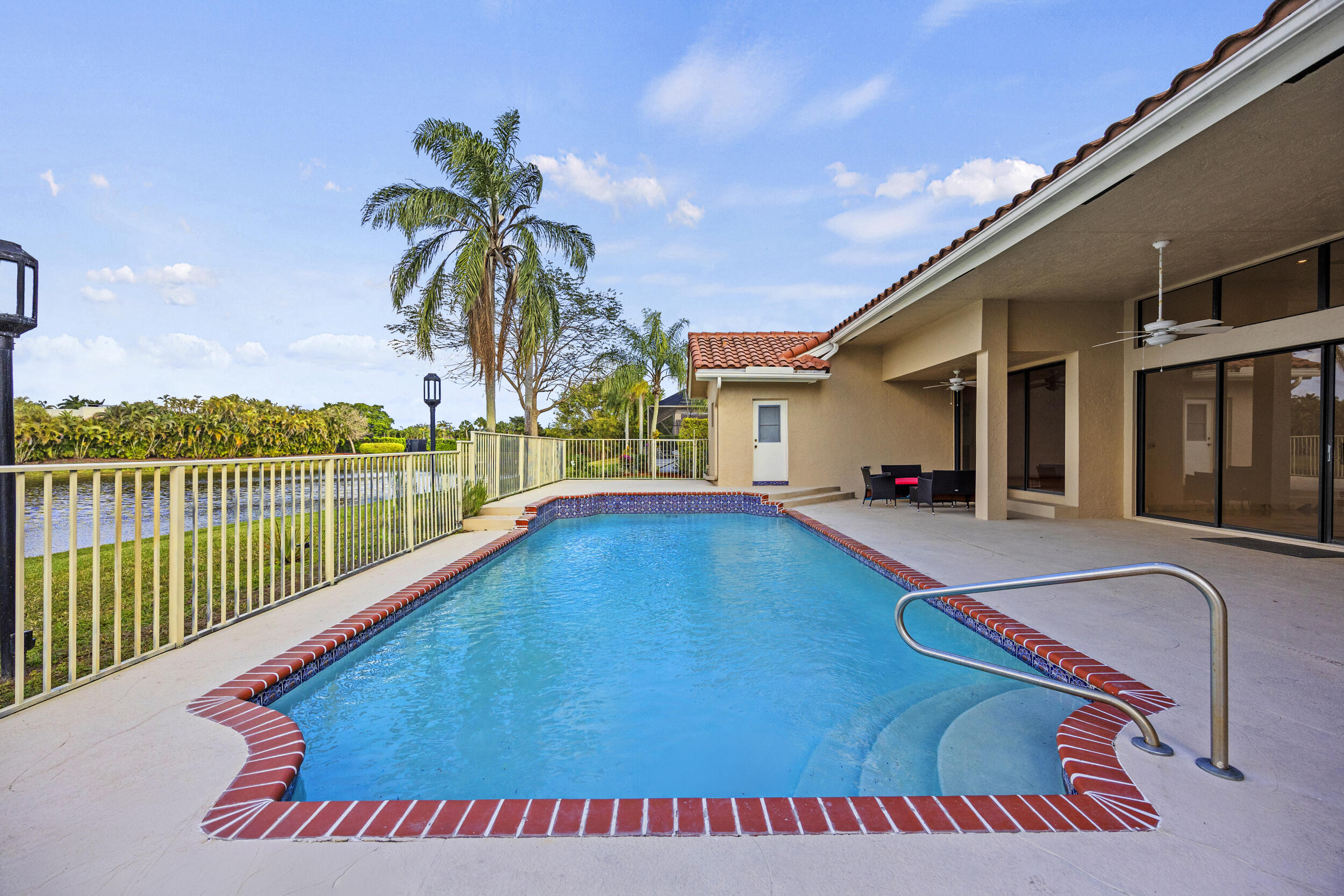 10747 Stonebridge Boulevard Boca Raton, FL 33498 - Photo 48 of 75 a view of swimming pool with a lounge chairs