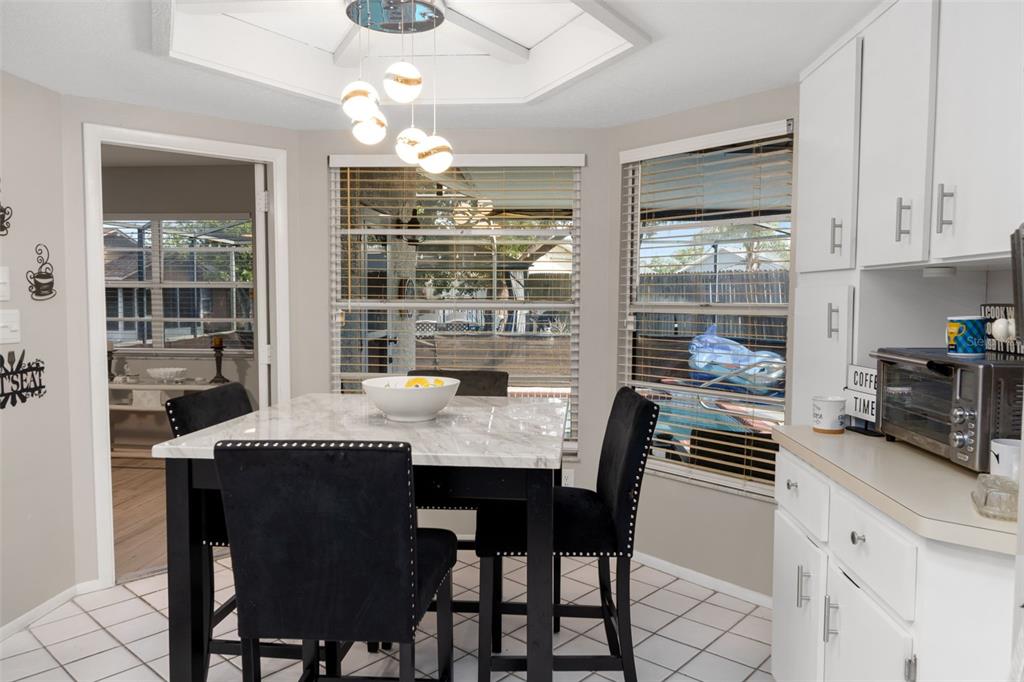 4355 Goldcoast Avenue Spring Hill, FL 34609 - Photo 11 of 30 a kitchen with a table chairs stove and cabinets