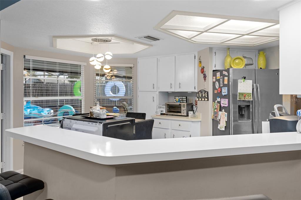 4355 Goldcoast Avenue Spring Hill, FL 34609 - Photo 12 of 30 a kitchen with a stove a refrigerator and a view of living room
